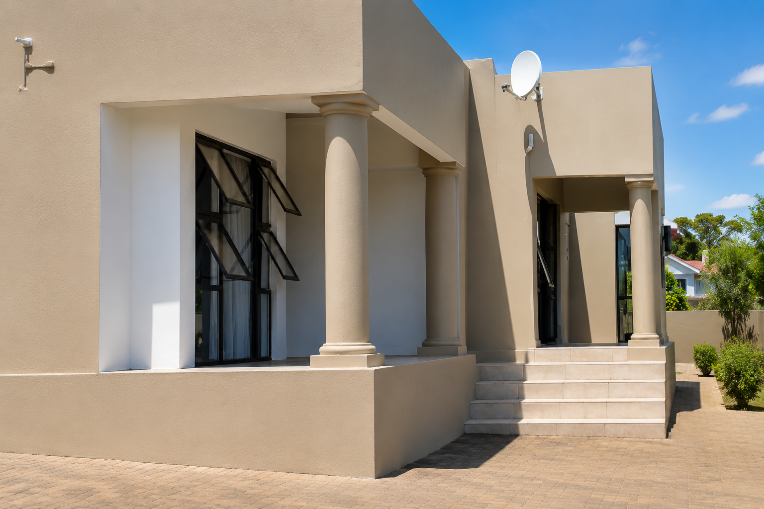 Columned entrance porch with tiled steps